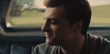 a close up of a man 's face looking out of a window