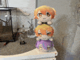 three stuffed animals are stacked on top of each other on a table with a sign that says " less monday "