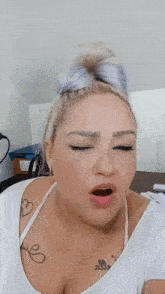 a woman with a tattoo on her chest that says ' elle '