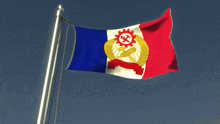 a red white and blue flag with a sun and hammer on it