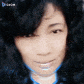 a close up of a woman 's face with a gocut logo on the bottom