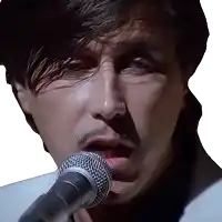 a man singing into a microphone with his mouth open