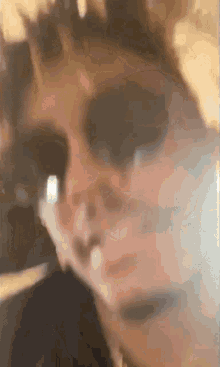 a close up of a person 's face wearing sunglasses .