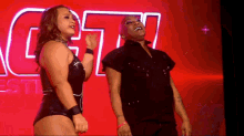 a man and a woman are dancing in front of a sign that says g7