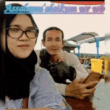 a man and a woman are sitting at a table .