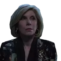 a close up of a woman 's face with a floral jacket and earrings