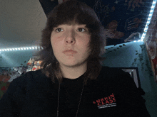 a young woman wearing a black shirt that says lurkin class