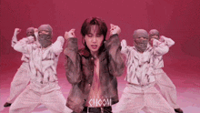 a group of people are dancing with the word choom on the bottom right