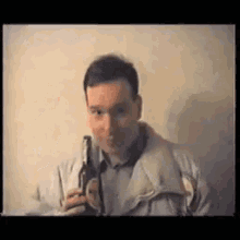 a man in a jacket is holding a beer bottle
