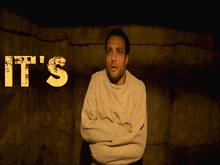 a man in a straight jacket stands in front of a sign that says it 's f ** king