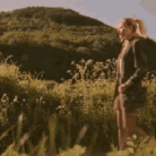 a blurry picture of a man standing in a field