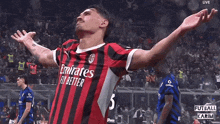 a soccer player wearing a emirates fly better jersey celebrates