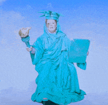 a woman dressed as the statue of liberty is holding a book that says ' freedom ' on it