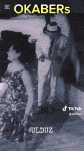a black and white photo of a man and a woman titled okabers uldz