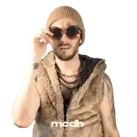 a man wearing sunglasses and a fur vest has the word mcdh on the bottom