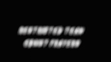 a blurred image of a person 's face with a black background and white letters .