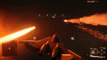 a fighter jet is flying through a dark sky with smoke coming out of it 's wings