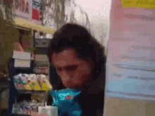 a blurry picture of a person eating something in a store
