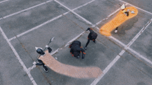 a group of people standing in a parking lot with fire coming out of them