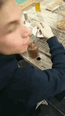 a person is mixing something in a glass with a fork