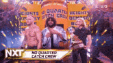 a group of wrestlers standing in front of a sign that says nxt no quarter catch crew