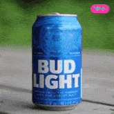 a blue can of bud light is sitting on a wooden table