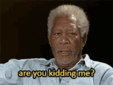 a man in a blue shirt is asking are you kidding me .
