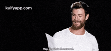 a man with a beard is wearing a white shirt and saying `` hey , i 'm chris hemsworth . ''