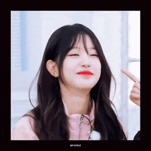 a girl in a pink jacket is making a face