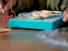 a person is playing a game with a blue box