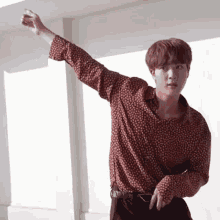 a man in a polka dot shirt is dancing