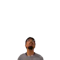 a man with glasses and a green cross on his head