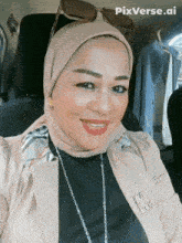 a woman wearing a hijab and sunglasses poses for a picture with pixverse.ai in the corner