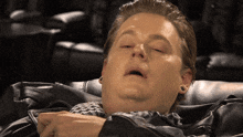 a man laying down with his eyes closed