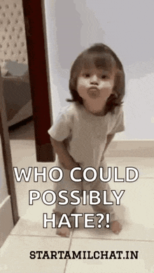 a little girl is making a funny face while standing on the floor .