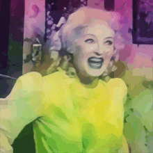 a woman in a yellow sweater is laughing with her mouth wide open