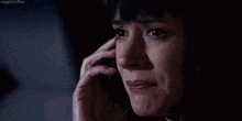 a woman is talking on a cell phone in the dark .