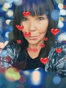 a woman is surrounded by red hearts and says photo lab on the bottom right