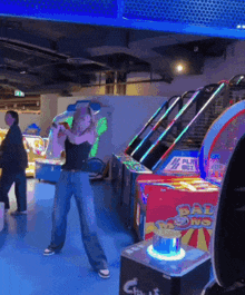 a woman is dancing in an arcade with a sign that says balloons