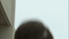 a close up of a woman 's head with her hair flying in the wind .