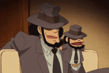 a man in a suit and hat is sitting next to a smaller man with a beard