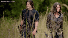 a man and a woman are walking through a field with the words dixonscarol tumblr visible