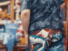 a person wearing a blue shirt with a shark on it