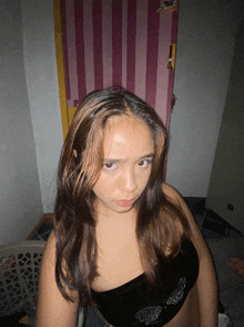 a woman taking a picture of herself in front of a door