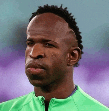 a close up of a man 's face wearing a green jacket and a mohawk .