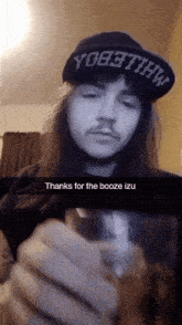 a man with long hair wearing a hat that says yo8tthw on it