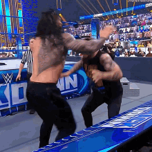 Kevin Owens Powerbomb GIF - Kevin Owens Powerbomb Roman Reigns GIFs