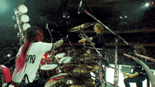 a drummer wearing a shirt with the number 10 on the front