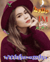 a woman wearing a red hat and a purple sweater says hello