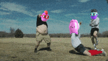 a group of people are doing push ups in a field and one of them has a pink balloon on his head that says 00
